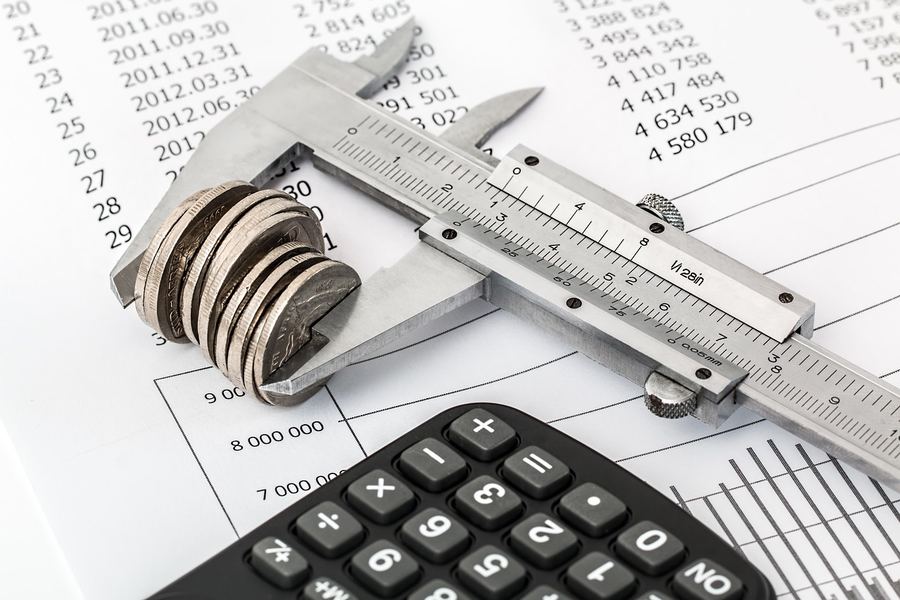 Coins, a calculator and financial paperwork.